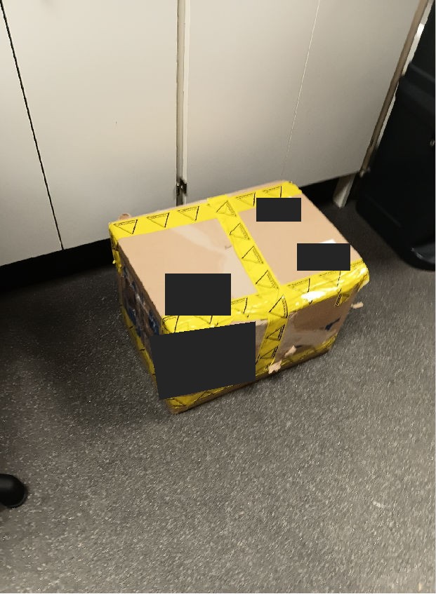 Delivered boxed consignment at a hospital pharmacy, with identifying labels redacted