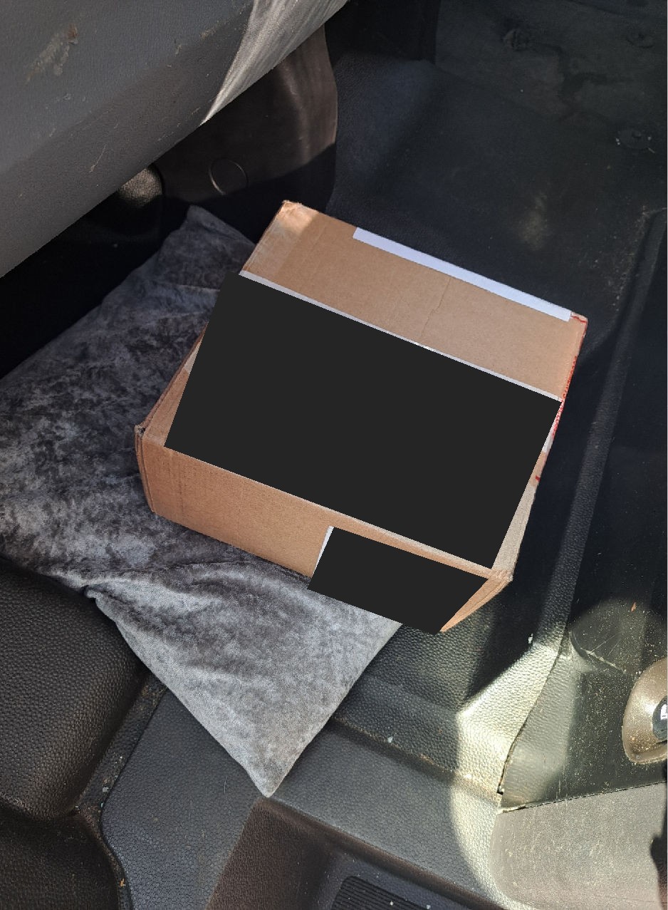 Healthcare consignment inside the SWB van, with product and shipping labels redacted
