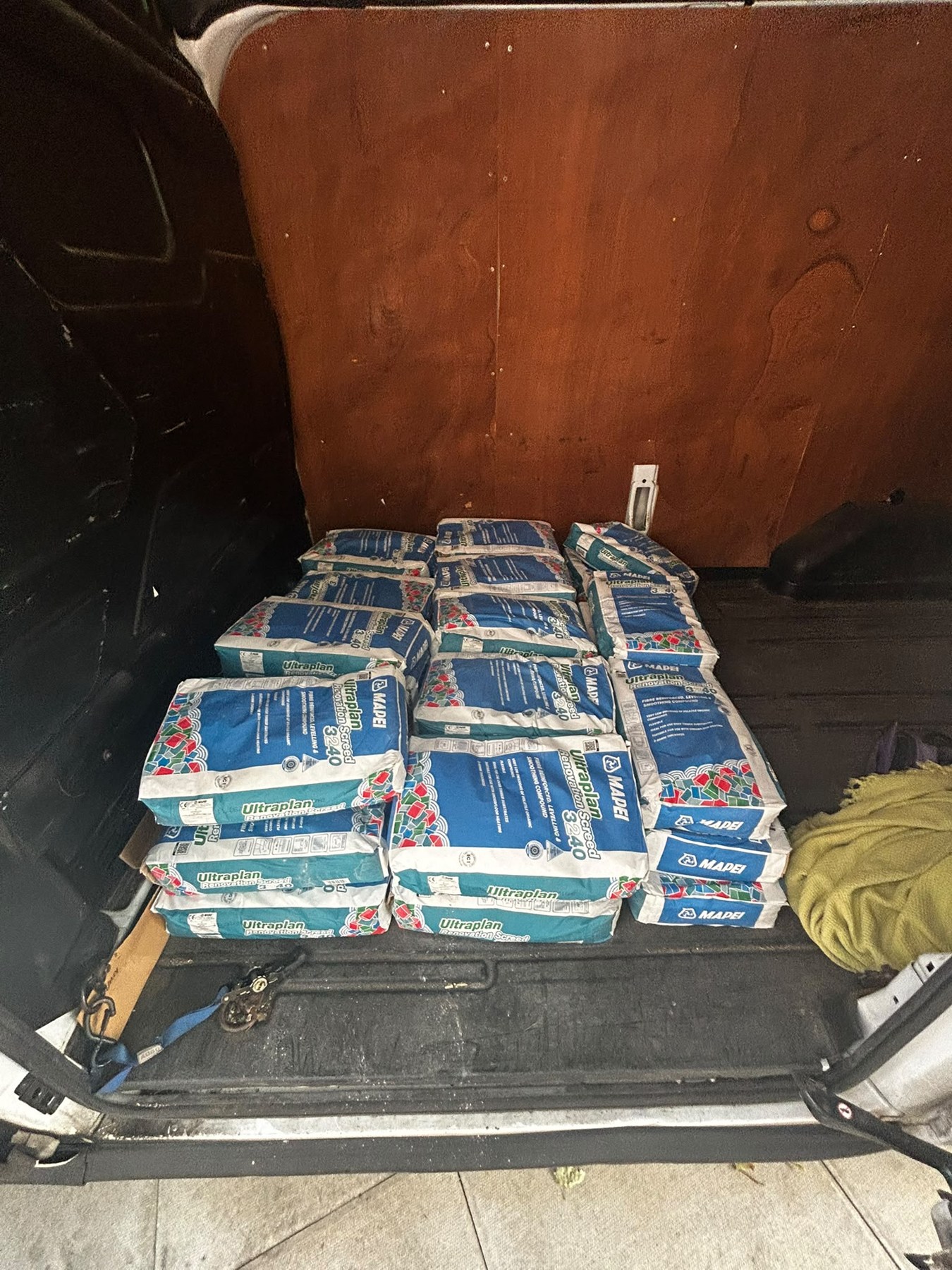 The 38-bag flooring-material collection inside the LWB van.