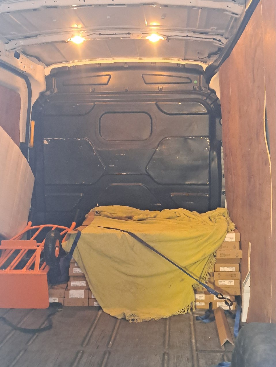 Boxed flooring protected and strapped inside the LWB van for the London delivery.