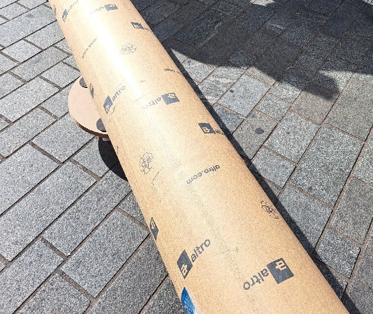 The flooring roll off the vehicle at the London delivery point; cropped to exclude bystanders.